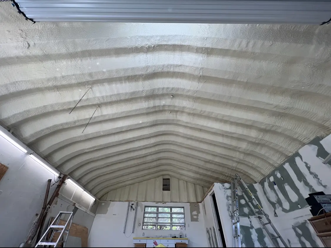 Spray polyurethane foam applied to the underside of a metal roof deck in Watauga